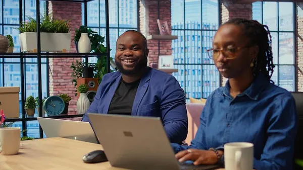 African couple working in an office — an article about property management software in Nigeria