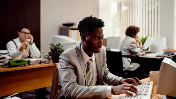 Business colleagues working in an office — an article about React website development Nigeria