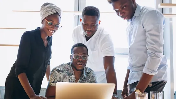 African business colleagues working in an office — an article about school management software in Nigeria