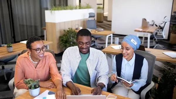 Business colleagues working in an office — an article about Shopify website development in Nigeria