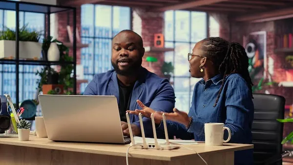 African business colleagues working in an office — an article about signs your business has outgrown Excel