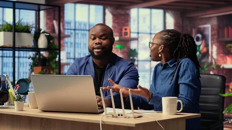 African business colleagues working in an office — an article about signs your business has outgrown Excel