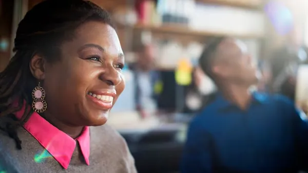 An African businesswoman at work in an office — an article about software maintenance cost in Nigeria