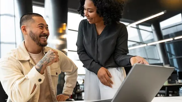Business colleagues working in an office — an article about technology solutions for Nigerian fashion businesses