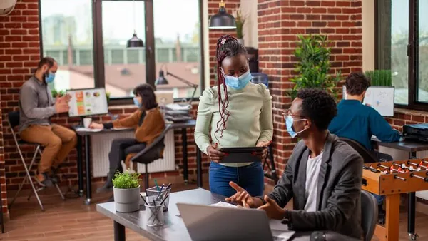 A businesswoman working in an office — an article about technology solutions for Nigerian hotels