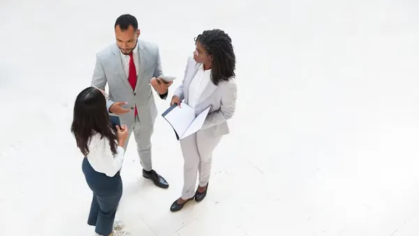 Business colleagues in a meeting in an office — an article about technology solutions for Nigerian recruitment agencies