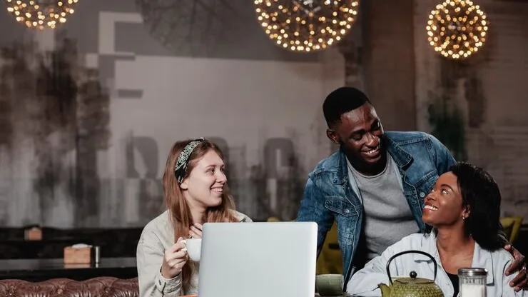 Business colleagues working in a cafe — an article about ticketing platform development in Nigeria
