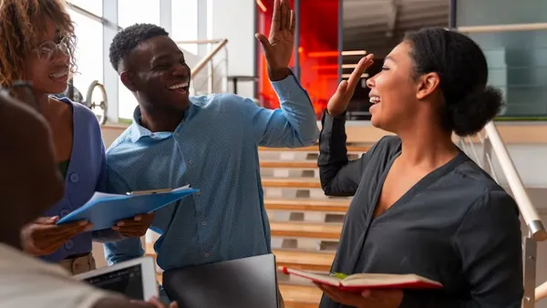 Business colleagues working in an office — an article about travel app development in Nigeria