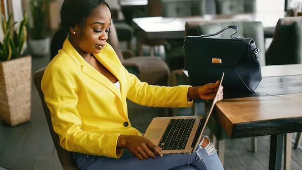 A businesswoman working in an office — an article about travel website development in Nigeria