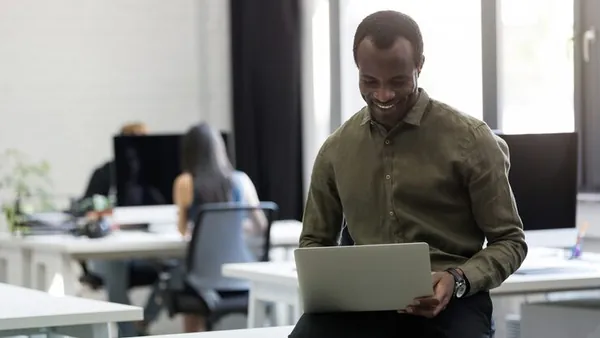 An African businessman working in an office — an article about website design for Nigerian doctors