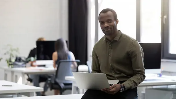 An African businessman at work in an office — an article about website design for Nigerian freelancers