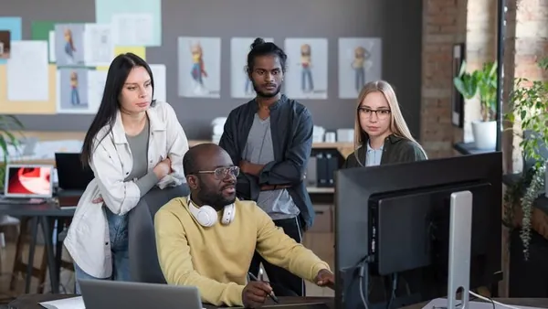 Business colleagues working in an office — an article about website design for Nigerian influencers