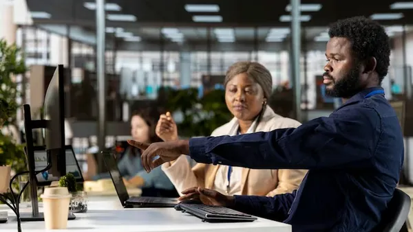 Business colleagues working in an office — an article about website development Abuja