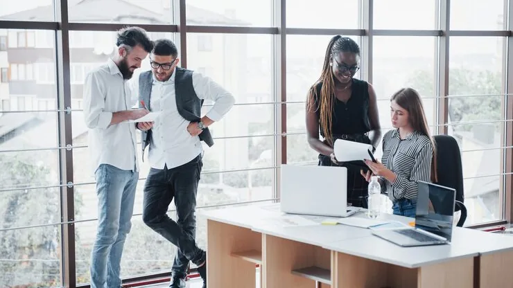 Business colleagues in a meeting in an office — an article about website development for event companies in Nigeria