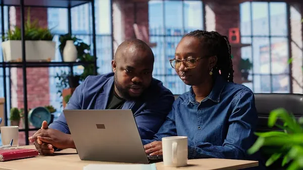 African business colleagues working in an office — an article about website development for transport companies in Nigeria