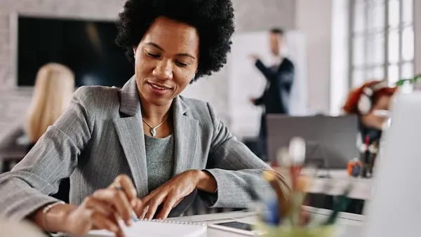 African business colleagues working over documents in an office — an article about website redesign cost in Nigeria