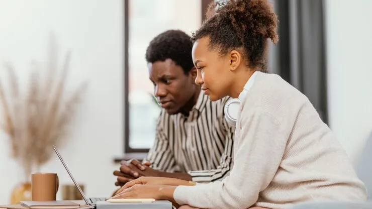 Business colleagues working in an office — an article about website security for Nigerian businesses