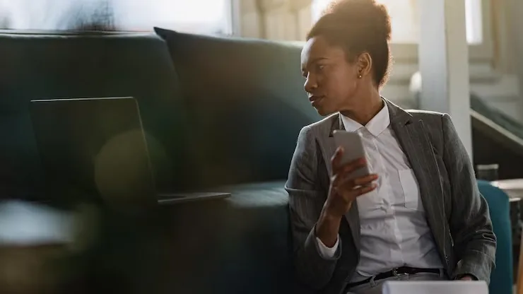 An African businesswoman reviewing on a laptop at home — an article about website vs mobile app for Nigerian businesses