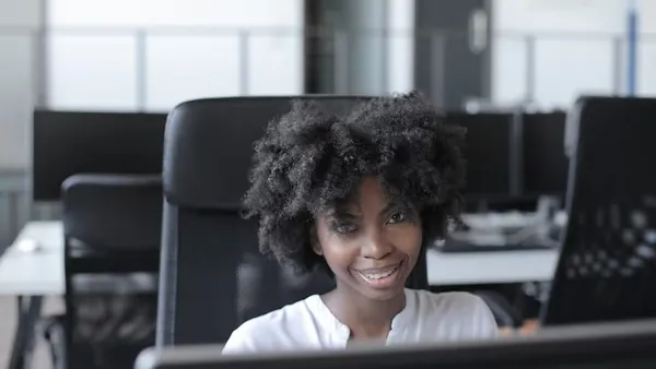 An African businesswoman working at a computer in an office — what happens after a website is launched