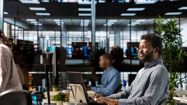 Business colleagues working in an office — an article about WhatsApp Business automation for Nigerian SMEs
