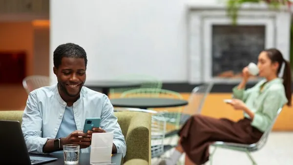 A businessman working on a phone in an office — an article about WhatsApp sales automation for Nigerian businesses
