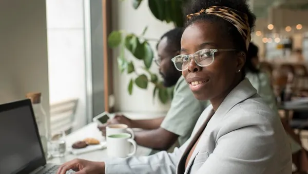 Business colleagues working in an office — an article about WhatsApp vs website for selling in Nigeria