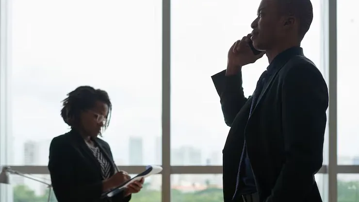 Business colleagues taking notes on a phone in an office — when should a business build a mobile app