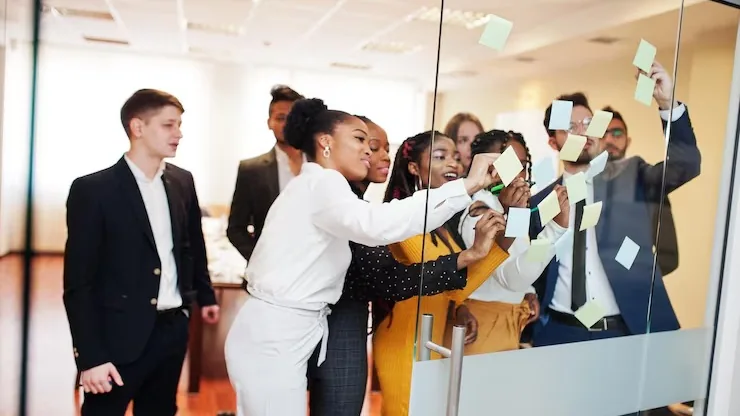 Business colleagues taking notes in an office — why Nigerian businesses need a CRM