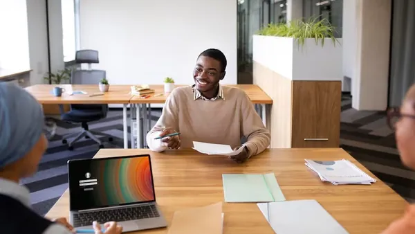 A businessman in a meeting in an office — an article about WordPress vs custom website